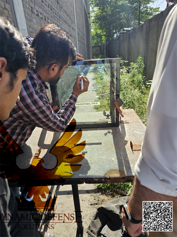 Dynamic Defense Solutions FZE ballistic glass during live firing test for armored vehicle protection.