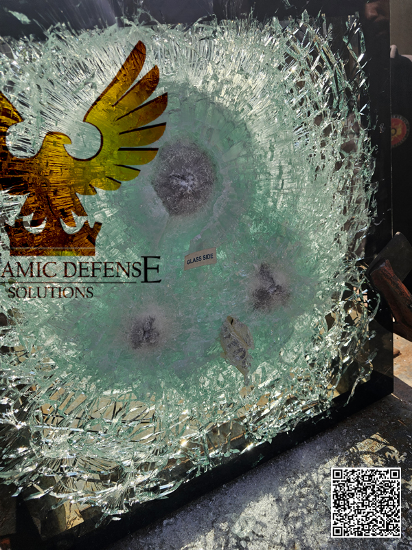 Close-up view of bullet impacts on high-protection armored glass after successful ballistic testing.